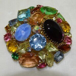 A BOUQUET OF COLORS ON A  BROOCH